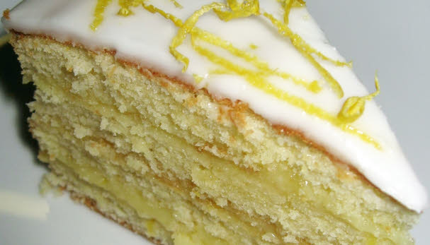 A slice of Victoria sandwich with frosted icing